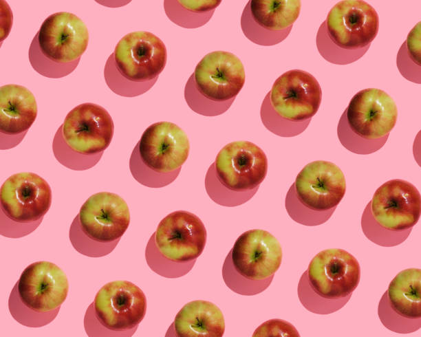 istock Autumn fruit pattern of fresh red apples on pink background, top view 2150302312