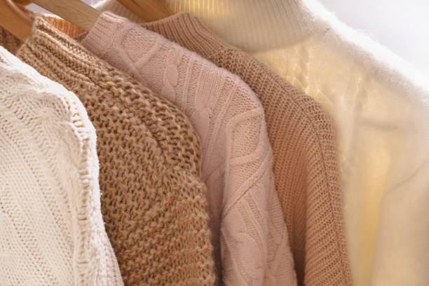 istock Winter sweaters hang in a row on a hanger, shoulders close-up 2150304860