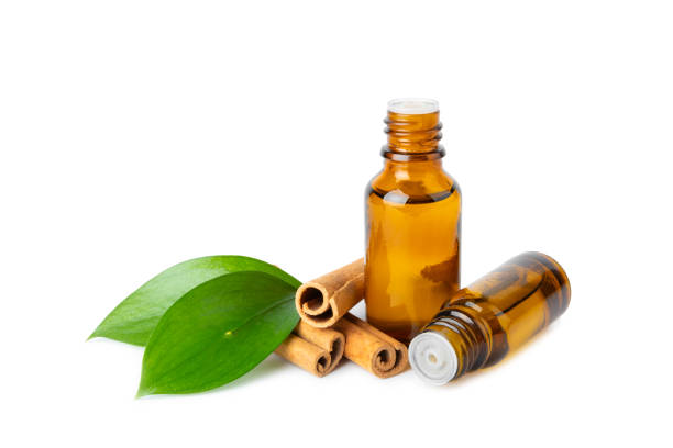 istock Cinnamon aromatic essential oil and cinnamon sticks isolated on white background. Aromatherapy. Organic cosmetic oil. Spa concept. 2150305214