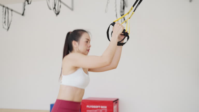 A woman is exercising with a resistance band