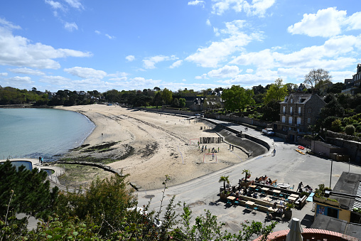 Dinard, France, april 18, 2024 : Prieuré beach in Dinard with a café terrace in the foreground