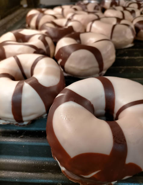 istock Donuts, white chocolate donuts with dark chocolate stripes in a freshly made bakery 2150307446