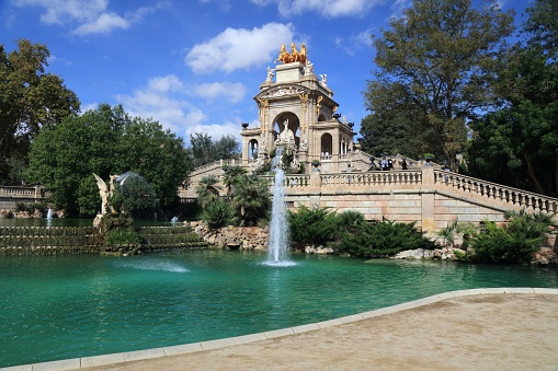 People visit Cascada fountain in Parc de la Ciutadella in Barcelona, Spain. Cascada was built in 1881.