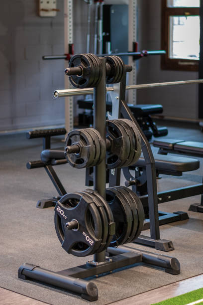 istock A black weight rack with several sets of barbell discs on it. 2150309403