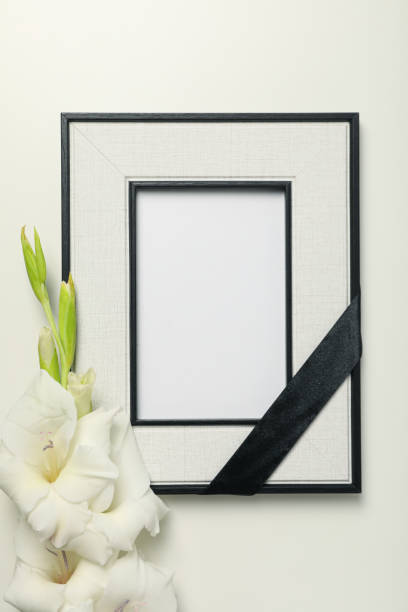 istock Photo frame with black ribbon and flower on white background, top view 2150310535