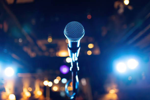 istock Microphone on stage against a background of auditorium. 2150310819