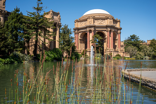 Rotunda of Palace of Fine Arts of San Francisco and its pond and fountain during springtime day