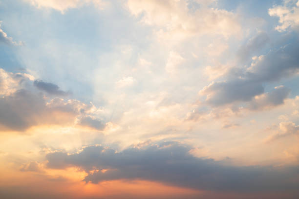 sunset or sun rise sky with rays of  light shining clouds and sky background and texture