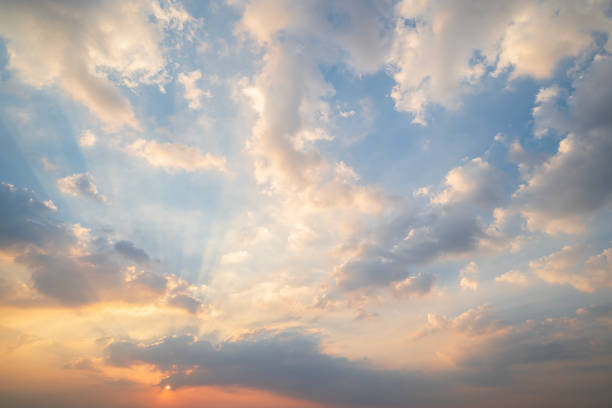istock sunset or sun rise sky with rays of  light shining clouds and sky background and texture 2150311954