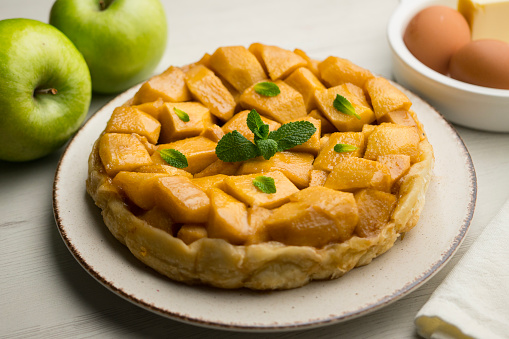 Tarte Tatin is a variant of apple pie in which the apples have been caramelized in butter and sugar before adding the dough..