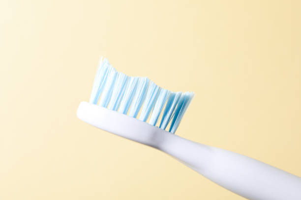 istock Blue electric toothbrush on beige background, close up 2150312356