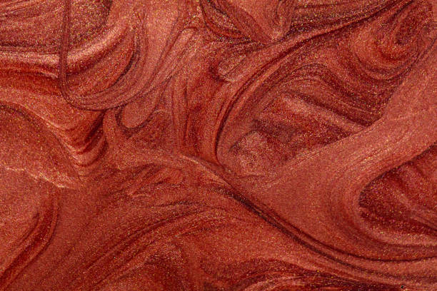 istock Closeup of red fluid metallic paint textured background 2150313533