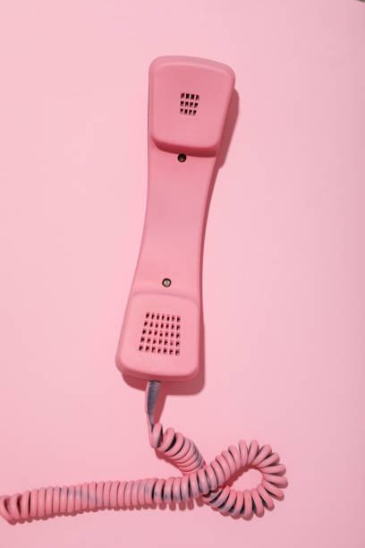 istock Vintage pink phone on pink background, top view 2150314609