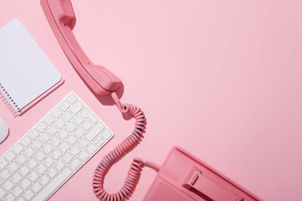 istock Vintage phone, keyboard and notepad on pink background, space for text 2150314772