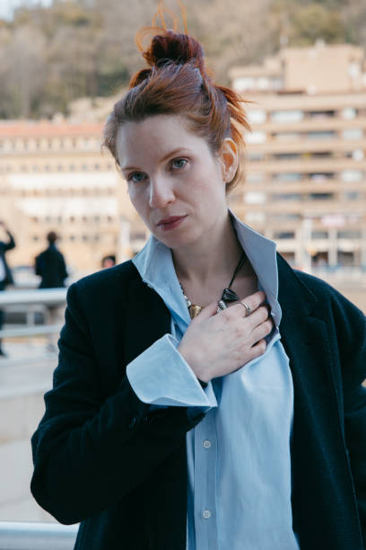 Confident redhead young woman pausing to gaze at the camera
