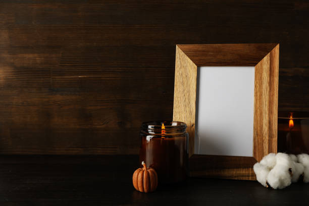 istock Candles and photo frame on wooden background, space for text 2150315291