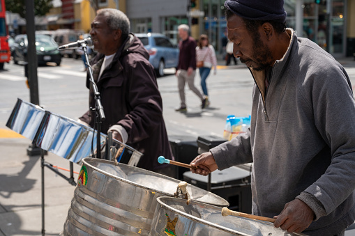 Black men playing music on the street in San Francisco during springtime day