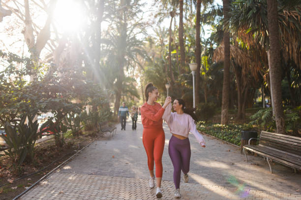istock Two beautiful women running together 2150316610
