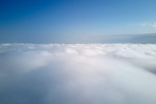 Aerial view from high altitude of earth covered with puffy rainy clouds forming before rainstorm