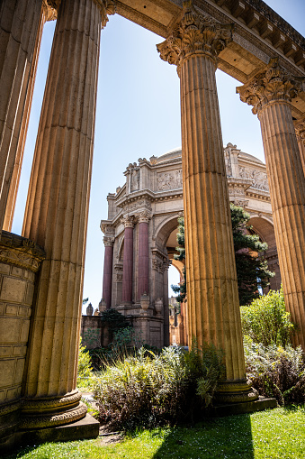 Rotunda of Palace of Fine Arts of San Francisco behind architectural columns during springtime day