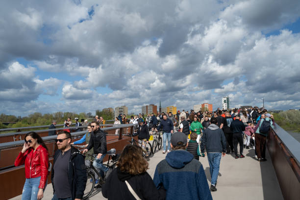 Pedestrians and cyclists on one of the longest pedestrian and bicycle footbridges in the world, the crossing is 452 meters long. The crossing connects the Vistula Boulevards with Praga in Warsaw.
