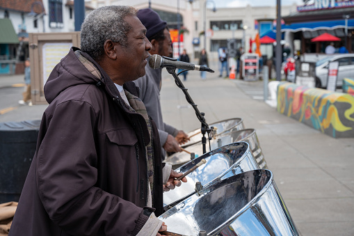 Black men playing music on the street in San Francisco during springtime day