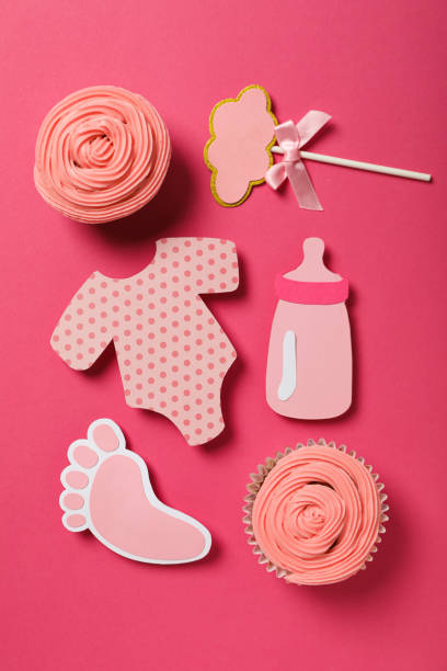 istock Cupcakes and paper baby things on pink background, top view 2150319701