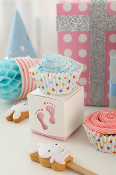 istock Cupcakes, gingerbread, gift box and paper cube on light background, close up. 2150320056