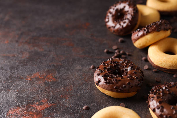 istock Chocolate donuts with chocolate chips on dark gray background, space for text 2150320804
