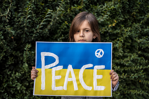 Young advocate for peace. A plea for ceasefire and solidarity reflects hope for resolution.