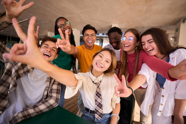 istock Portrait group of cheerful young multiracial university students posing smiling doing peace gesture 2150322126