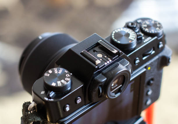 istock The black retro designed camera is mounted on a tripod for making photo or video footage. Wheels on the camera for setting up. 2150323202