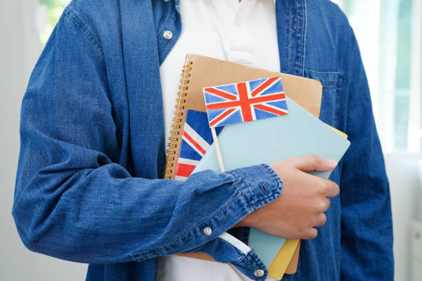 istock Learning English, Asian teenage student holding book with flag for language program education. 2150323666