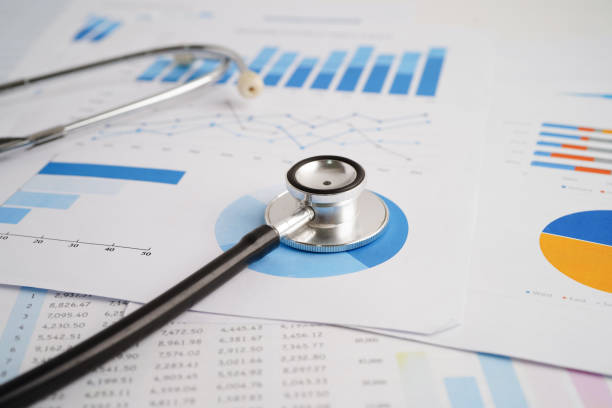 istock Stethoscope and US dollar banknotes on chart or graph paper, Financial, account, statistics and business data  medical health concept. 2150323818