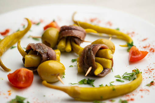 Gilda is a traditional pincho or tapa from the Basque Country that is prepared with anchovies, olives and pickled chillies..