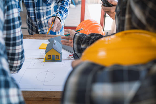 istock Architects and designers are talking about Construction plans before being delivered to the engineering team and foremen for construction. Audit concept Plans from a team of architects and designers 2150324506