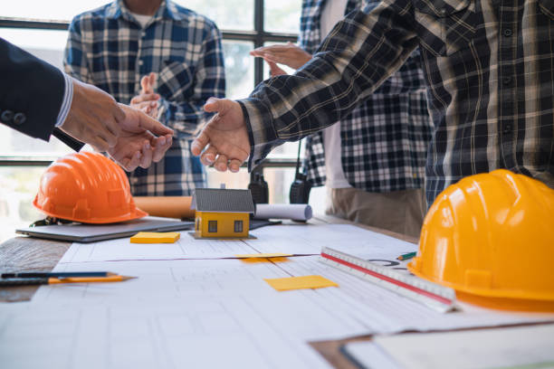istock Architects and designers are talking about Construction plans before being delivered to the engineering team and foremen for construction. Audit concept Plans from a team of architects and designers 2150324534