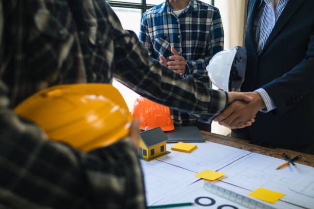 istock Architects and designers are talking about Construction plans before being delivered to the engineering team and foremen for construction. Audit concept Plans from a team of architects and designers 2150324555