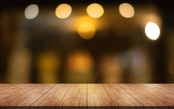 istock Empty wooden table top with lights bokeh on blur restaurant background. 2150325064