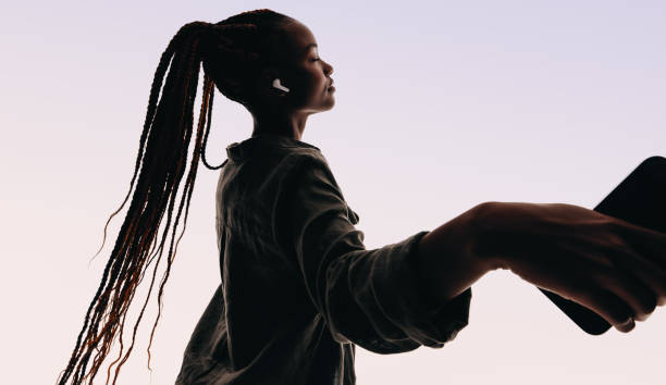 istock Young woman with dreadlocks dances to music in a studio. 2150325374