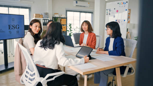 istock Business professionals in discussion at a table, deeply engaged in collaboration and ESG strategic planning in the office. 2150326196