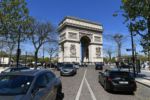 Paris, France-04 23 2024: Cars in front of the Arc de Triomphe in Paris, France.