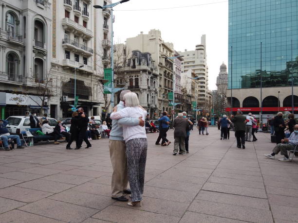 Top view of an unrecognizable couple walking on a modern city pavement