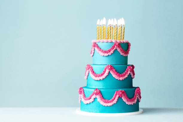 istock Tiered celebration birthday cake with ornate piped buttercream frills 2150327012