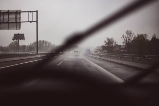 car driving through the fog on a wet road