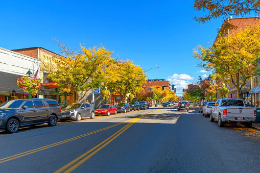 Sherman Avenue, the main street of shops and cafes through the lakeside small town of Coeur d'Alene, Idaho, in the Idaho panhandle at autumn with fall colors on the trees.