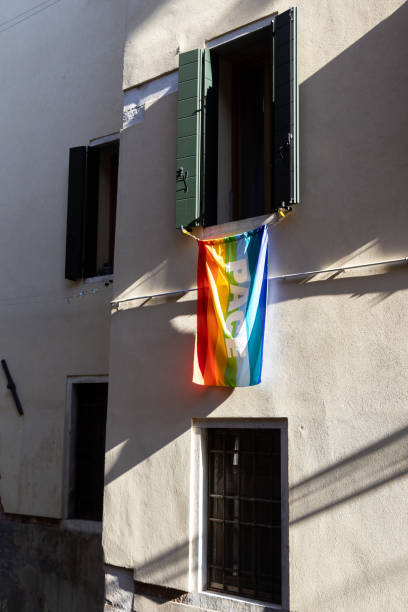 istock Italian rainbow flag waving from a window in Venice with Pace (peace) written on it 2150331607