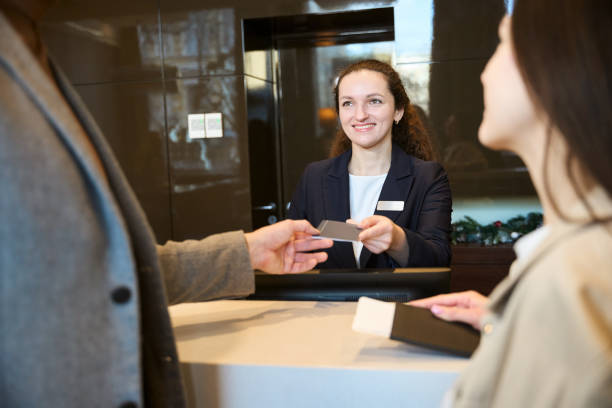 istock Man and woman checking into hotel on arrival 2150331713