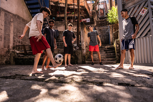 Young friends playing soccer outdoors