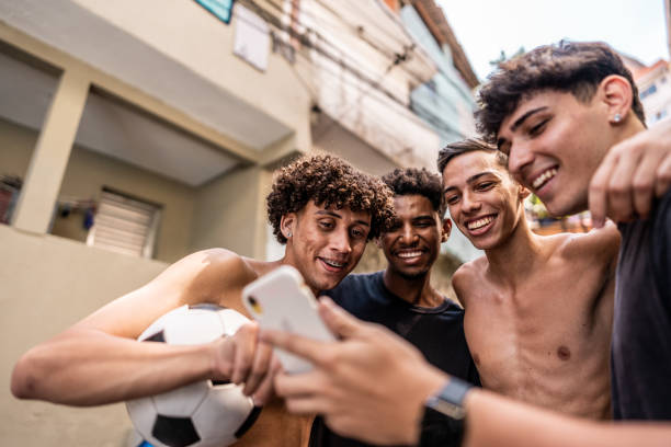 istock Young friends using the mobile phone in the street 2150334621